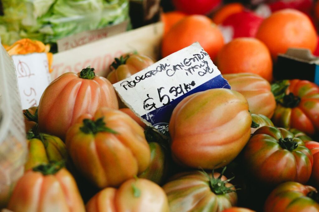 Close-up of organic tomatoes in a vibrant market setting, showcasing fresh produce.